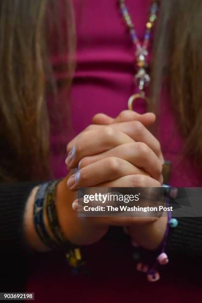 Delegate Danica Roem clasps her hands in prayer on the floor of the House of Delegates on her first day in office at the Virginia State Capitol on...