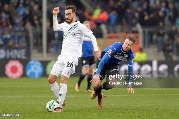 Kenan Karaman of Hannover and Brian Behrendt of Bielefeld battle for the ball during the H-Hotels.com Wintercup match between Arminia Bielefeld and...