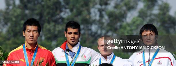 Gold medalist Ahmadreza Talebian of Iran , silver medalist Pan Yao of China , and joint bronze medalists Yasuhiro Suzuki of Japan and Aleksandr Parol...