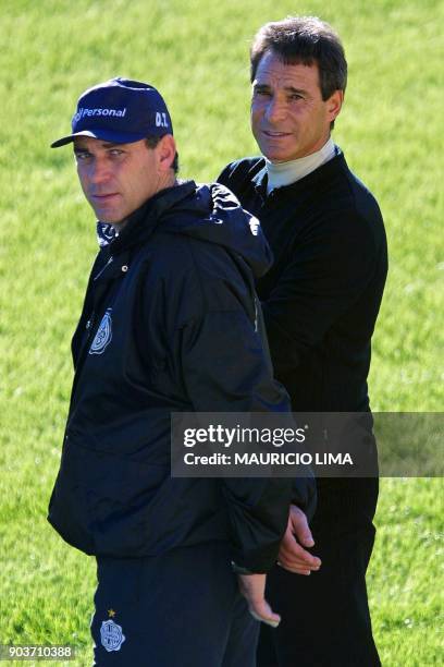 Nery Pumpido , coach of the Olimpia team, and Paul Cesar Carpegiani watch the team during a friendly game in Porto Alegre, Brazil, 16 July 2002. Nery...