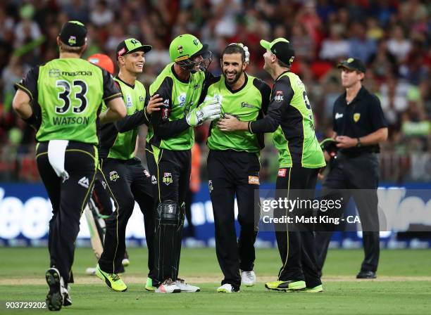 Fawad Ahmed of the Thunder celebrates with team mates after taking the wicket of Adam Voges of the Scorchers during the Big Bash League match between...