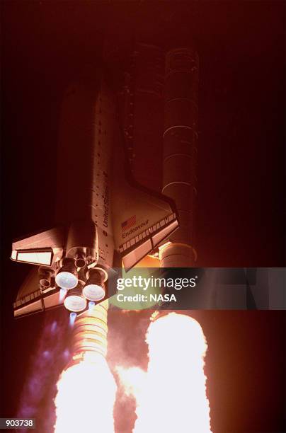 The Space Shuttle Endeavour lights up the night sky as it embarks on the first U.S. Mission dedicated to the assembly of the International Space...