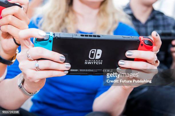 Detail of a young woman playing video games on a Nintendo Switch home console, taken on March 7, 2017.