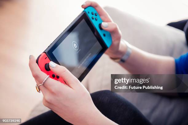 Detail of a young woman playing video games on a Nintendo Switch home console, taken on March 7, 2017.