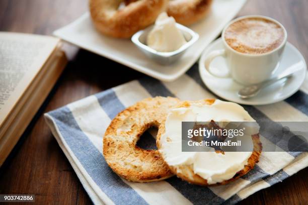 montreal style bagels on a plate with cream cheese and coffee - montréal stock pictures, royalty-free photos & images