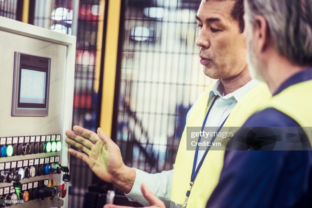 Engineer Control Panel Asian Engineer Explaining Control Panel To Colleague High-Res Stock ...