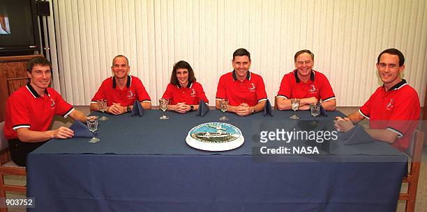As part of the final STS-88 prelaunch activities, the six crew members gather for a last meal before liftoff and a photo opportunity in the...