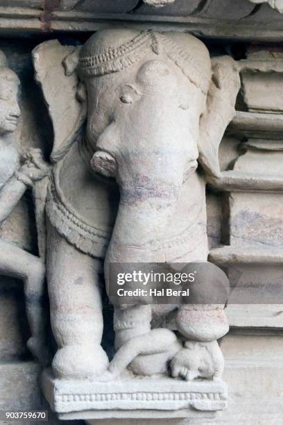 stone carving showing elephant crushing a prisoner as execution method - khajuraho statues stock pictures, royalty-free photos & images