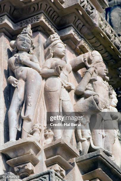 stone carved figures of beautiful women on the kandariya mahadev temple - khajuraho statues stock pictures, royalty-free photos & images