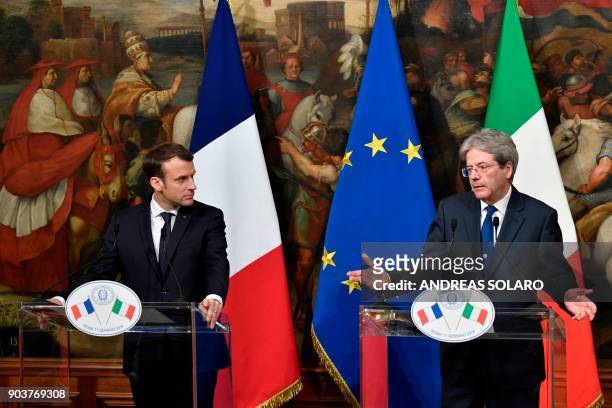 Italian Prime Minister Paolo Gentiloni and France's President Emmanuel Macron give a joint press conference after their meeting on January 11, 2018...