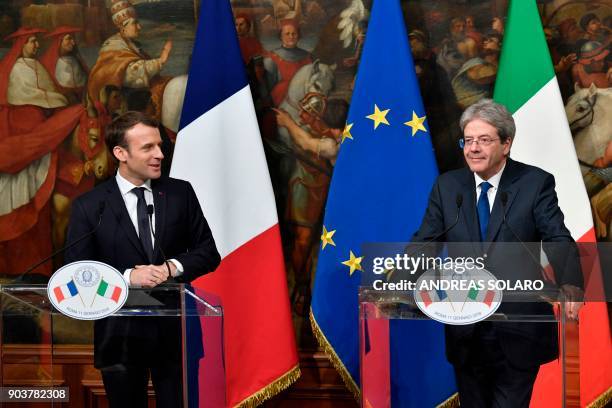 France's President Emmanuel Macron and Italian Prime Minister Paolo Gentiloni give a joint press conference after their meeting on January 11, 2018...
