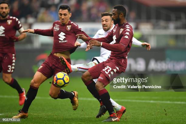 Federico Di Francesco of Bologna FC is challenged by Nicolas Burdisso and Nicolas N koulou of Torino FC during the serie A match between Torino FC...