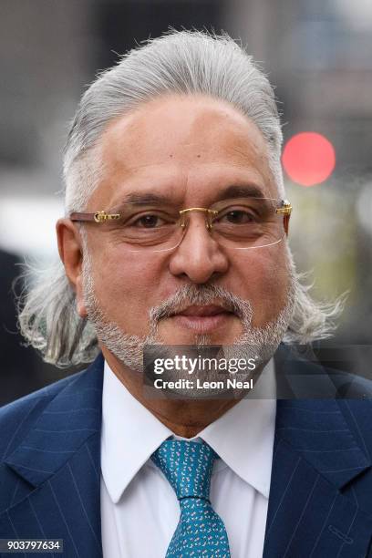 Force India team boss Vijay Mallya walks through the press as he arrives at The City of Westminster Magistrates Court on January 11, 2018 in London,...