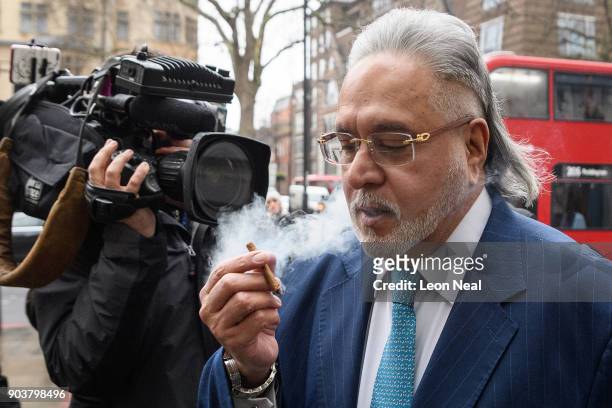 Force India team boss Vijay Mallya walks through the press as he arrives at The City of Westminster Magistrates Court on January 11, 2018 in London,...