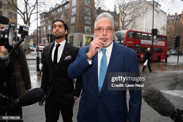 Force India team boss Vijay Mallya walks through the press with his son Siddharth Mallya , as he arrives at The City of Westminster Magistrates Court...