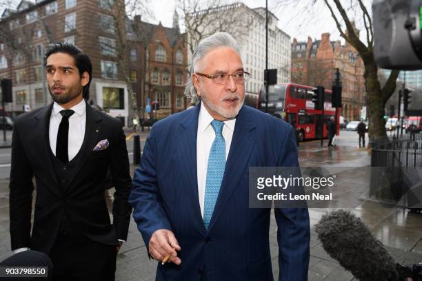 Force India team boss Vijay Mallya walks through the press with his son Siddharth Mallya , as he arrives at The City of Westminster Magistrates Court...