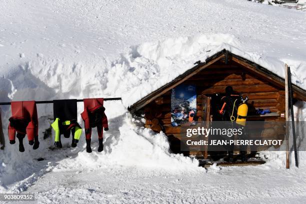 Vacationer wearing special equipment brings back his gear after ice diving at minus two degrees Celsius, in the frozen lake of Val Claret, in the...