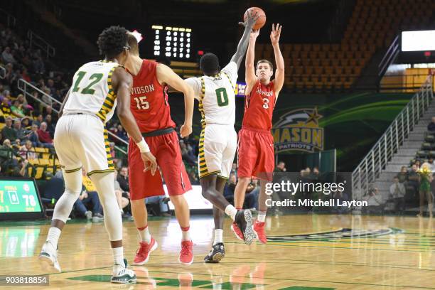 Jon Axel Gudmundsson of the Davidson Wildcats takes a jump shot during a college basketball game against the George Mason Patriots at the Eagle Bank...