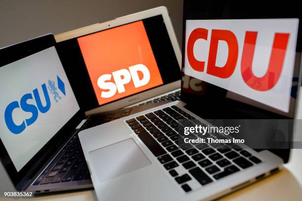 An illustration shows the logo of the German parties CDU, SPD and CSU on laptop displays, on January 11, 2018 in Berlin, Germany.