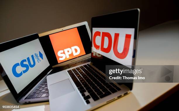 An illustration shows the logo of the German parties CDU, SPD and CSU on laptop displays, on January 11, 2018 in Berlin, Germany.