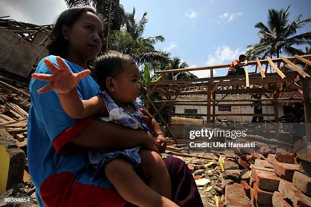 People rebuild their home, following the September 2nd earthquake, on September 6, 2009 in Cigalontang, West Java, Indonesia. The 7.0-magnitude...