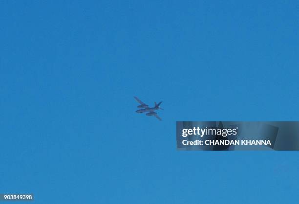 Light bomber aircraft identified as either an Ilyushin Il-28 or its Chinese copy known as the H-5 flies over the North Korean town of Sinuiju as seen...
