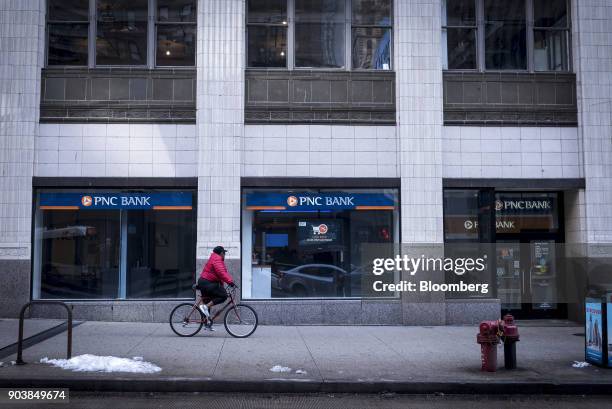 Cyclist rides past a PNC Financial Services Group Inc. Bank branch in downtown Chicago, Illinois, U.S., on Monday, Jan. 8, 2018. PNC Financial...