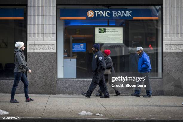 Pedestrians pass in front of a PNC Financial Services Group Inc. Bank branch in downtown Chicago, Illinois, U.S., on Monday, Jan. 8, 2018. PNC...