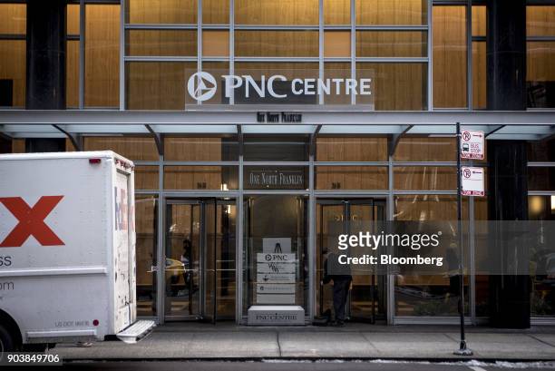 Worker sweeps in front of the PNC Financial Services Group Inc. Centre in downtown Chicago, Illinois, U.S., on Tuesday, Jan. 9, 2018. PNC Financial...