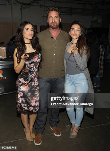 Jessica Cediel and her sister Virginia Cediel are seen posing with Gerard Butler on the set of "Despierta America" at Univision Studios on January...