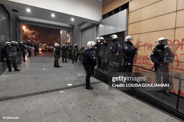 Police guard a side exit of the Greek Ministry of Finance in Athens on January 11 during a protest by communist-affiliated All-Workers Militant Front...