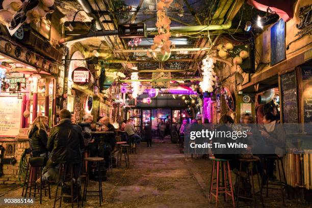 szimpla bar at night, district 7, budapest, hungary - busy bar stock pictures, royalty-free photos & images