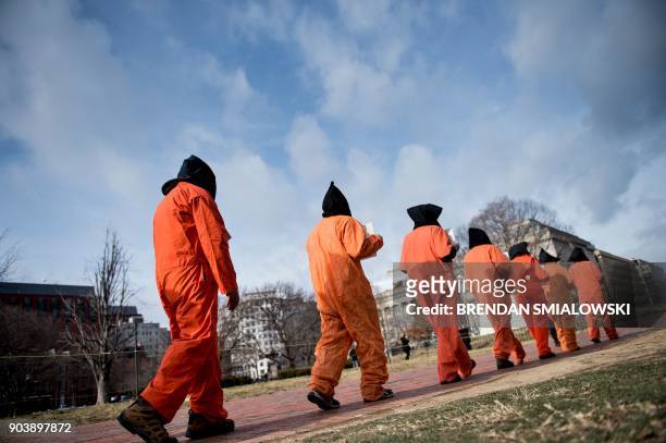 Activists protest the Guantanamo Bay detention camp during a rally in Lafayette Square outside the White House January 11, 2018 in Washington, DC. /...
