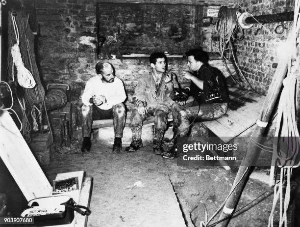 News correspondent Piers Anderton , and NBC News cameraman Peter Dehmel , talk with West Berlin student Dominico Sesta recently, in the basement of a...