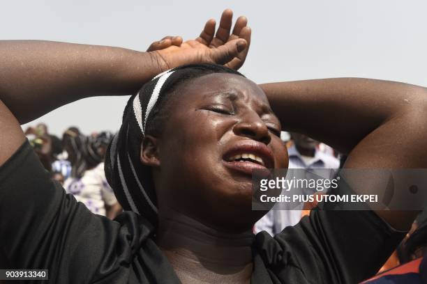 Lady burst to tears as casket of father was brought at Ibrahim Babangida Square, during the funeral service for people killed during clashes between...
