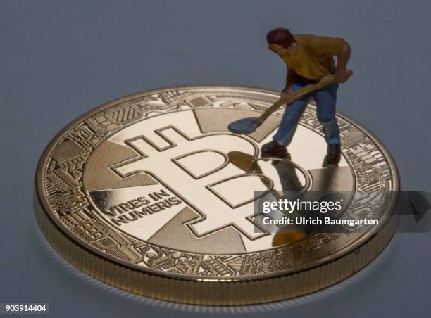 Fascination and uncertainty - Bitcoin. Symbol photo on the topic crypto currency Bitcoin. The picture shows Bitcoin and a worker with a shovel.