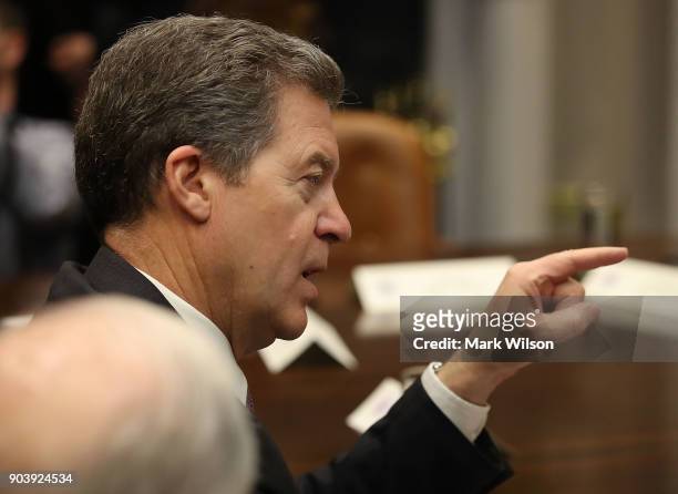 Kansas Governor Sam Brownback participates in a prison reform roundtable with U.S. President Donald Trump in the Roosevelt Room at the White House,...