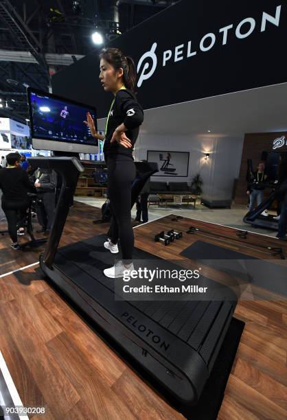 Maggie Lu demonstrates using a Peloton Tread treadmill during CES 2018 at the Las Vegas Convention Center on January 11, 2018 in Las Vegas, Nevada....