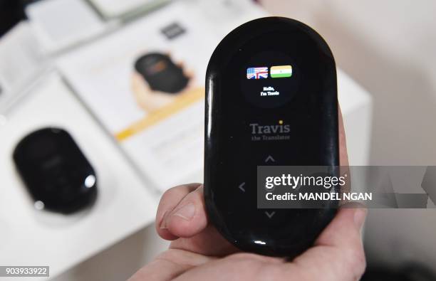 An exhibitor shows the Travis translator at the Eureka Park startups area during CES 2018 in Las Vegas on January 11, 2018. Large crowds pack the...
