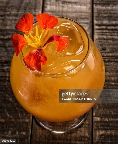 "Charanda" cocktail made with sugar cane schnapps typical of the Mexican state of Michoacan, with raspberry shrub, orange juice and a splash of...