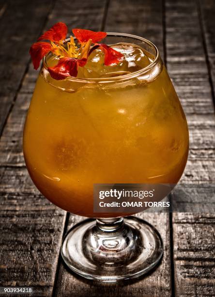 "Charanda" cocktail made with sugar cane schnapps typical of the Mexican state of Michoacan, with raspberry shrub, orange juice and a splash of...