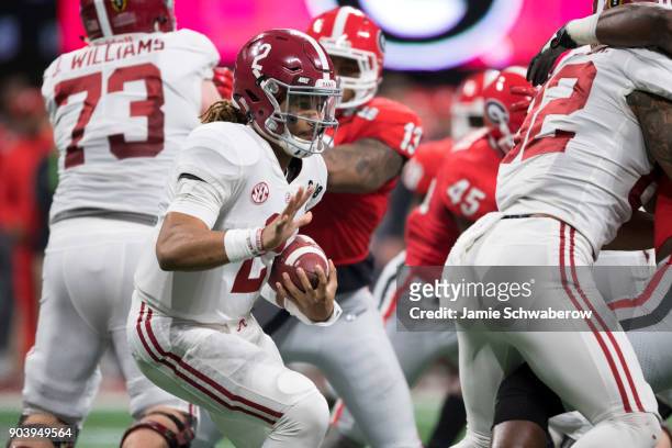 Jalen Hurts of the Alabama Crimson Tide rushes against the Georgia Bulldogs during the College Football Playoff National Championship held at...