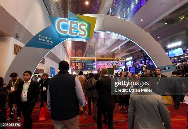 Attendees walk under a CES sign in the lobby during CES 2018 at the Las Vegas Convention Center on January 11, 2018 in Las Vegas, Nevada. CES, the...