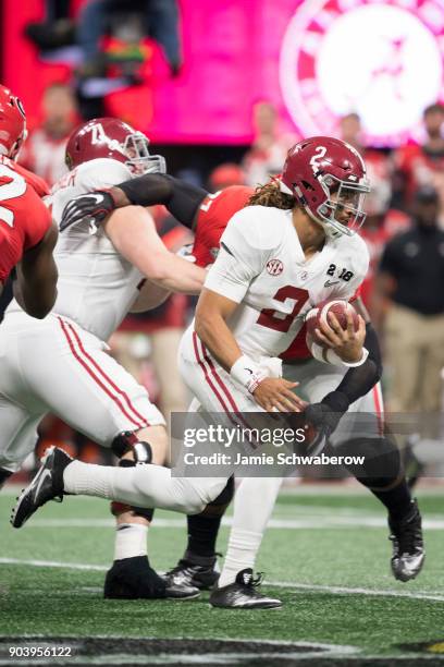 Jalen Hurts of the Alabama Crimson Tide rushes against the Georgia Bulldogs during the College Football Playoff National Championship held at...