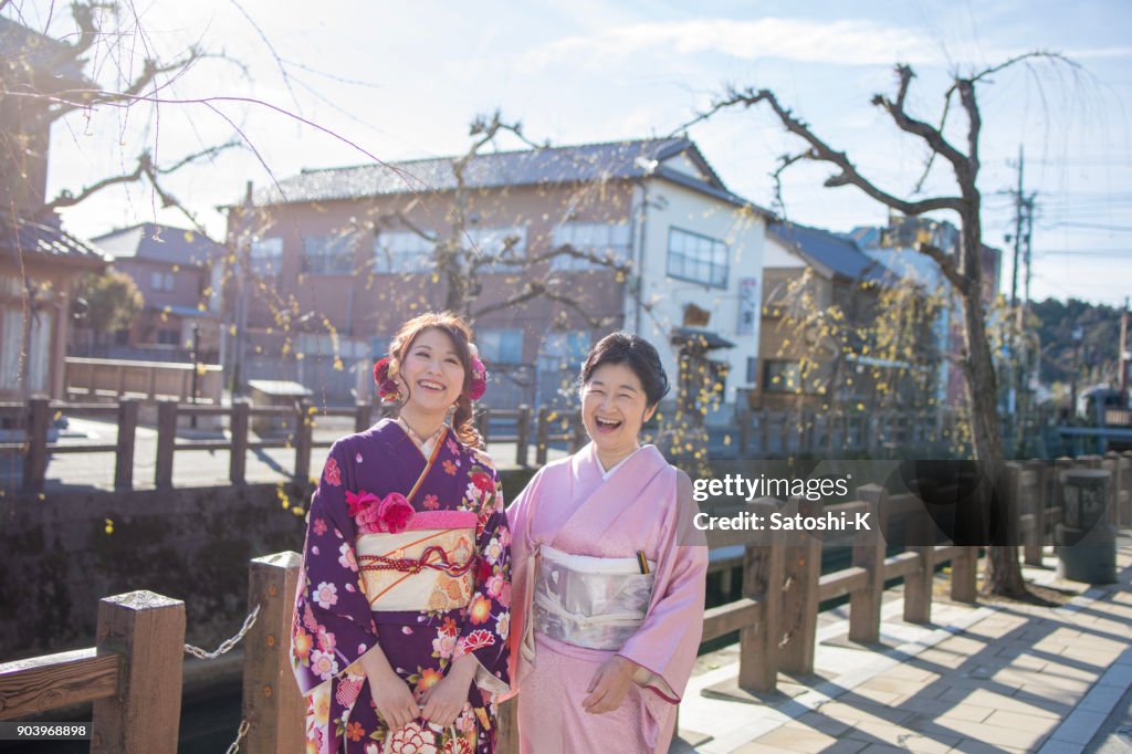 Happy mother and daughter on coming of age day