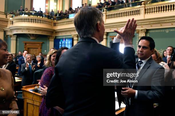 January 11: Governor John Hickenlooper hi 5's State Representative Dan Pabon after delivering his last Colorado State of the State address at the...