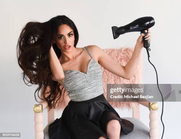 Blaze Modelz Niyousha Fozoonmayeh using FHI Heat blow dryer sitting in a Ulloo forty two chair at New Faces at TAP - The Artists Project on January...