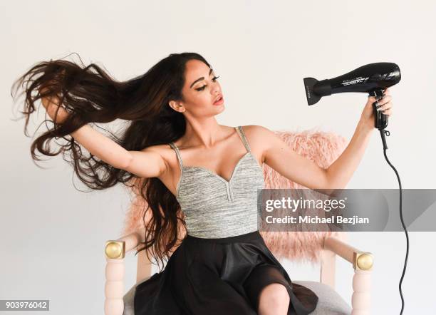 Blaze Modelz Niyousha Fozoonmayeh using FHI Heat blow dryer sitting in a Ulloo forty two chair at New Faces at TAP - The Artists Project on January...