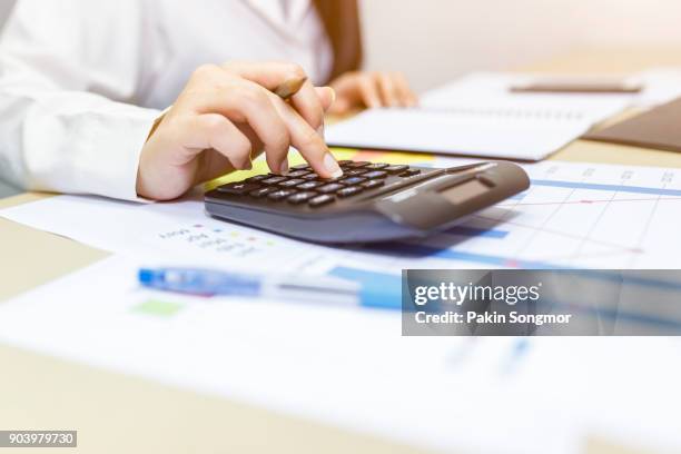 close up right hand female using calculator - retirement income stock pictures, royalty-free photos & images