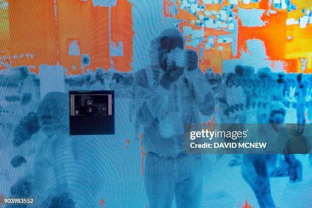 Thermal imaging cameras show a live image people people at the FLIR exhibit at CES in Las Vegas, Nevada, January 11, 2018. / AFP PHOTO / DAVID MCNEW